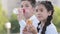 Two hungry children schoolchildren pupils students brother and sister hispanic kids friends sitting outdoors in school