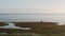 Two hydrologists wearing antimosquito screens on their heads examine ground and make measures. Descover Yamal peninsula.