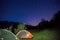 Two illuminated tents at mountains