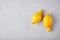 Two imperfect lemons at grey slate background. Ugly Fruits concept. Incorrect shape lemons