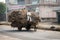 Two Indian boys ride a horse with loaded cart on a road