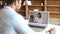 Two indian colleagues or friends speaking through the screen, using laptop