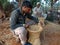 Two indian craft man making dry grass chair at agriculture field in india oct 2019