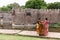 Two Indian women wearing saris having a cheerful conversation at the Vellore Fort
