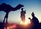 Two Indigenous Indian Men Resting Camel Concept