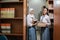 two Indonesian high school girls carrying standing books with copy space