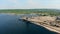 Two industrial machines are discharging gravel from a barge