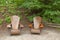 Two inviting wooden Lawn chairs