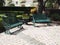 Two iron park benches by a patio