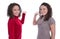 Two isolated girls presenting over white background making promo