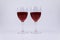Two isolated glasses full of red wine on white background
