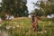 Two Italian greyhounds in a green field