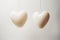 Two ivory minimal hearts shaped balloons. Generate ai