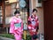 Two Japanese girl in Kimono dress walking on the walkway in Kyoto.