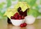 Two jars of jam closed striped paper, bowl with cherries and sugar on table