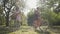 Two joy girlfriends riding bicycles in the summer park or garden. Girls passing by the camera. Rural life. Retro style