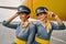 Two joyful air hostesses on the runway