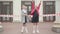 Two joyful carefree schoolgirls rejoicing school closure for Covid-19 pandemic lockdown. Happy Caucasian girls waving to