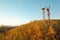 Two joyful children jumped and raised hands up - sunset after summer day.