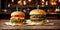 Two juicy cheeseburgers close-up on a wooden table on a kitchen board against a background of a blurred rustic