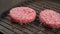 Two juicy cutlets of minced meat are fried on the grill in oil