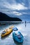 Two kayak and tourists relaxing on the rock beach at dusk. Phuket Island