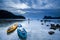 Two kayak and tourists relaxing on the rock beach at dusk. Phuket Island