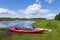 Two kayaks by the river bank. Scenic rural landscape of wild river, rafting along a river, water sport concept