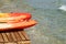 Two kayaks on a wooden pier near the sea