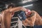 Two kickboxers fighting on a boxing ring and looking aggressive