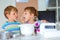 Two kid boys baking cake in domestic kitchen