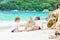 Two kid boys building sand castle on tropical beach