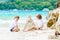 Two kid boys building sand castle on tropical beach