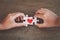 Two kid hands connecting couple jigsaw puzzle with drawn red heart