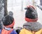 Two kid in winter clothing covering with snow fall on heavy snow weather