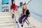 Two kids: Beautiful Children play on the railing in the street on the stairs.