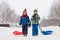 Two kids, boy brothers, sliding with bob in the snow, wintertime