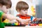 Two kids brothers play together at table