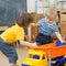 Two kids conflict or struggling for toy truck in kindergarten