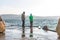 Two kids on a dock on a stormy day