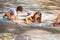 Two kids draw outside in chalk hopscotch