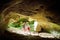 Two kids exploring old caves dug into the tuff rock and used for human habitation in ancient times. Citta del Tufo archaeological