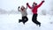Two kids jumping together on winter landscape, slow motion
