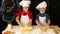 Two kids kneading the dough for christmas cookies