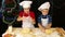 Two kids kneading the dough for christmas cookies together