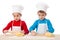 Two kids kneading the dough together