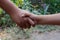 Two kids make hand shake