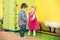 Two kids in Montessori preschool Class. girl and boy playing in kindergarten