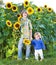 Two kids playing together in a sunflower field