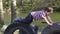 Two kids playing together on tires in playground